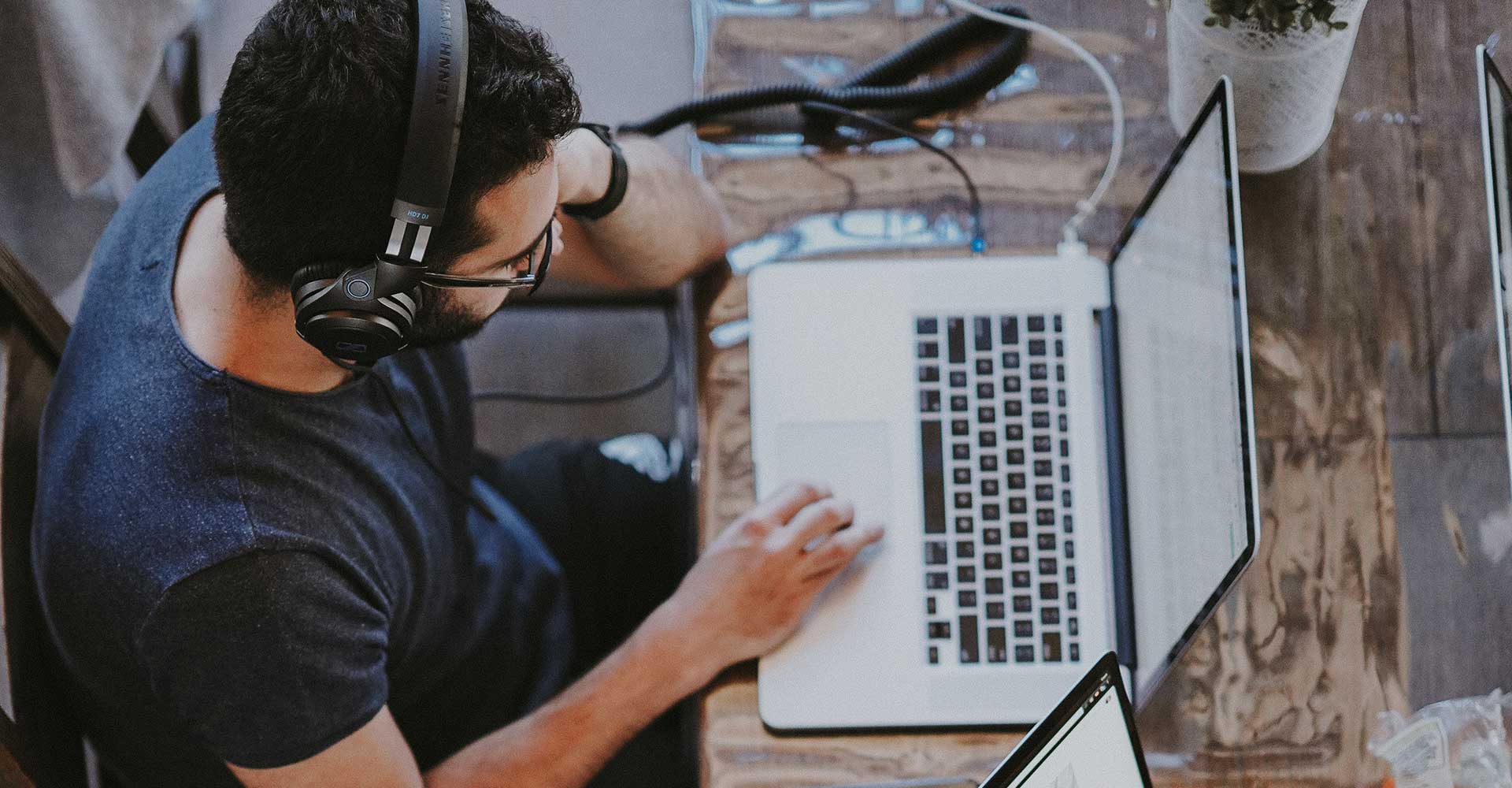 Image of a man working with headphones depicting advertiser previewing own ad